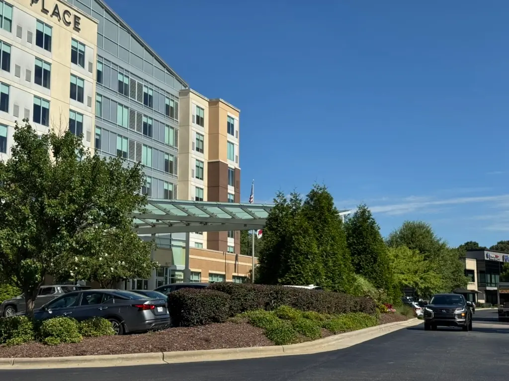 Professionally landscaped hotel and commercial property with well-maintained trees and shrubs.